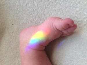 Infant_foot_w_rainbow_spectrum_Adam_Segulah_Sher
